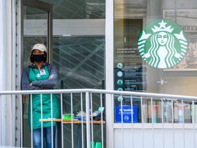 A worker stands inside Starbucks in midtown on May 20, 2020, in New York City.