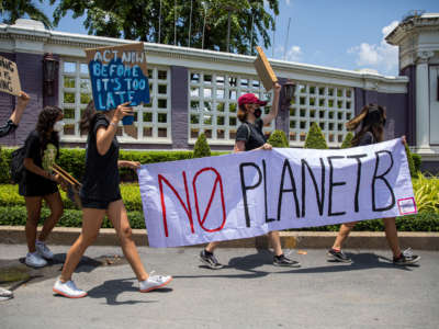 Environmental activists hold a sign that says 'no planet B' during an Earth Day rally on April 22, 2022, in Bangkok, Thailand.