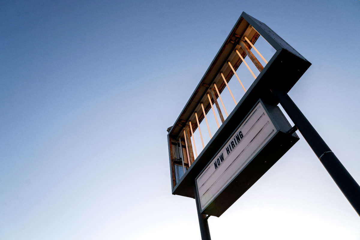 A Now Hiring sign is displayed in front of a restaurant in Rehoboth Beach, Delaware, on March 19, 2022.