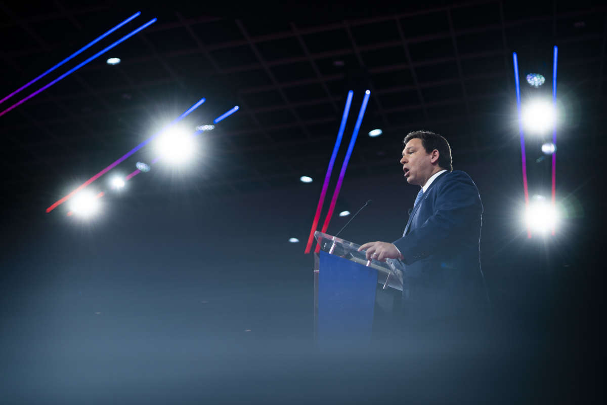 Ron DeSantis speaks into a microphone