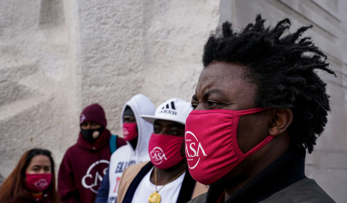 Charles Lwanga, right, of Cameroon, is among the crowd gathered at the Martin Luther King Jr. Memorial to remember the Black immigrants who were recently deported, on February 10, 2021, in Washington, D.C.