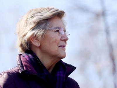 Sen. Elizabeth Warren listens during a press conference during a press conference in Boston's Mattapan on March 14, 2022.