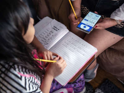 A parent helps their child with homework