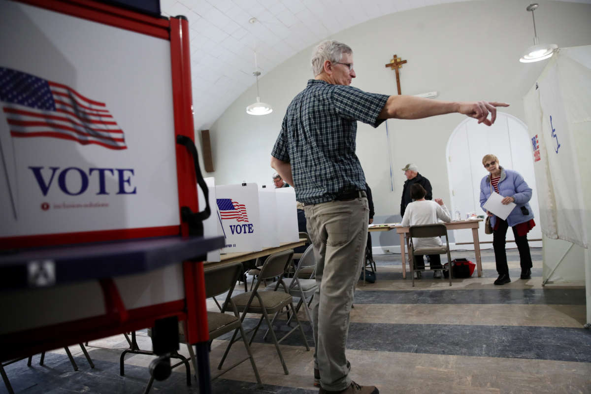A volunteer directs voters at the Parish of the Assumption (St. Joseph Church) in Dover, New Hampshire, on February 11, 2019.