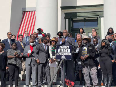 Pastor RB Holmes, with Bethel Missionary Baptist, organizers and Black Florida lawmakers gather to speak against a congressional map proposed by Gov. Ron DeSantis on April 19, 2022.