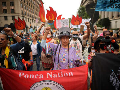 Demonstrators march to the White House during the third of five days of civil disobedience during the 'Climate Chaos Is Happening Now' protest on October 13, 2021, in Washington, D.C.