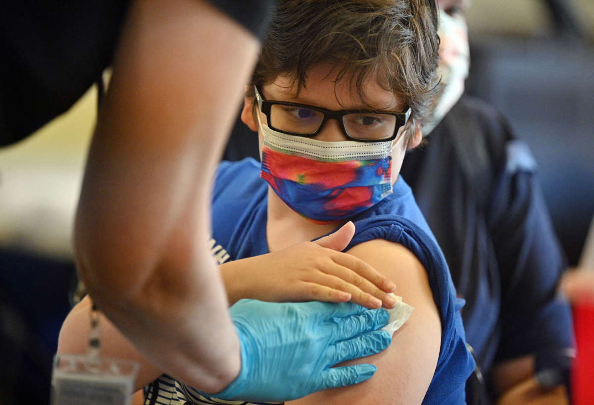 A boy receives a COVID-19 vaccine at a L.A. Care Health Plan vaccination clinic at Los Angeles Mission College in Los Angeles, California, on January 19, 2022.