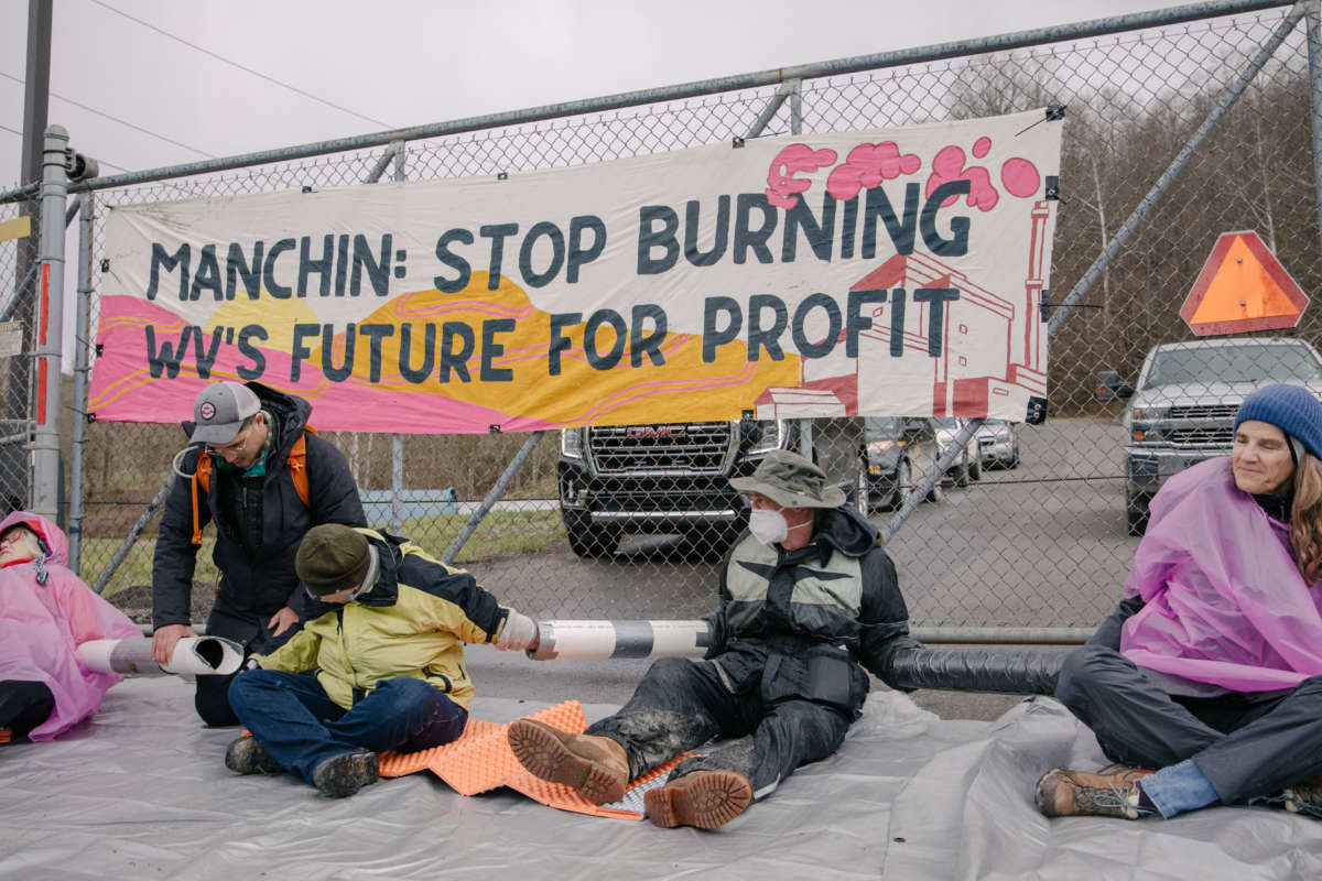 Activists with West Virginia Rising blockade the entrance to Sen. Joe Manhin's family business at the Grant Town Power Plant on April 9, 2022. Sixteen were arrested.