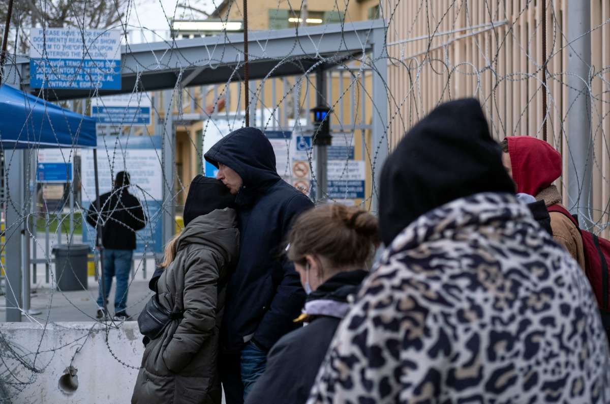 Asylum seekers from Ukraine stand in line before crossing to the United States, on the Mexican side of the San Ysidro Port of Entry in Tijuana, Mexico, on April 2, 2022.