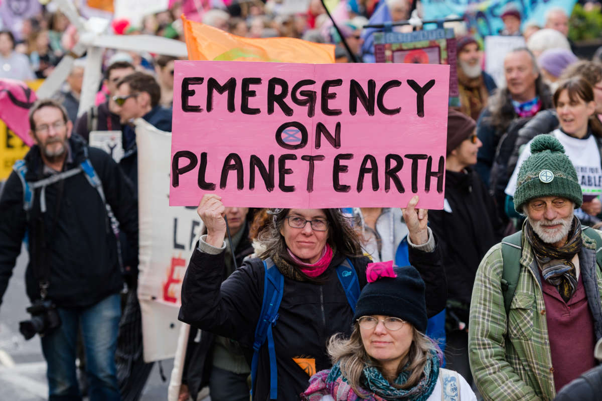 Activists from Extinction Rebellion march on the first day of a week long wave of protests and civil disobedience actions to demand an immediate stop to all new fossil fuel infrastructure by the British government amid climate crisis and ecological emergency on April 9, 2022, in London, England.