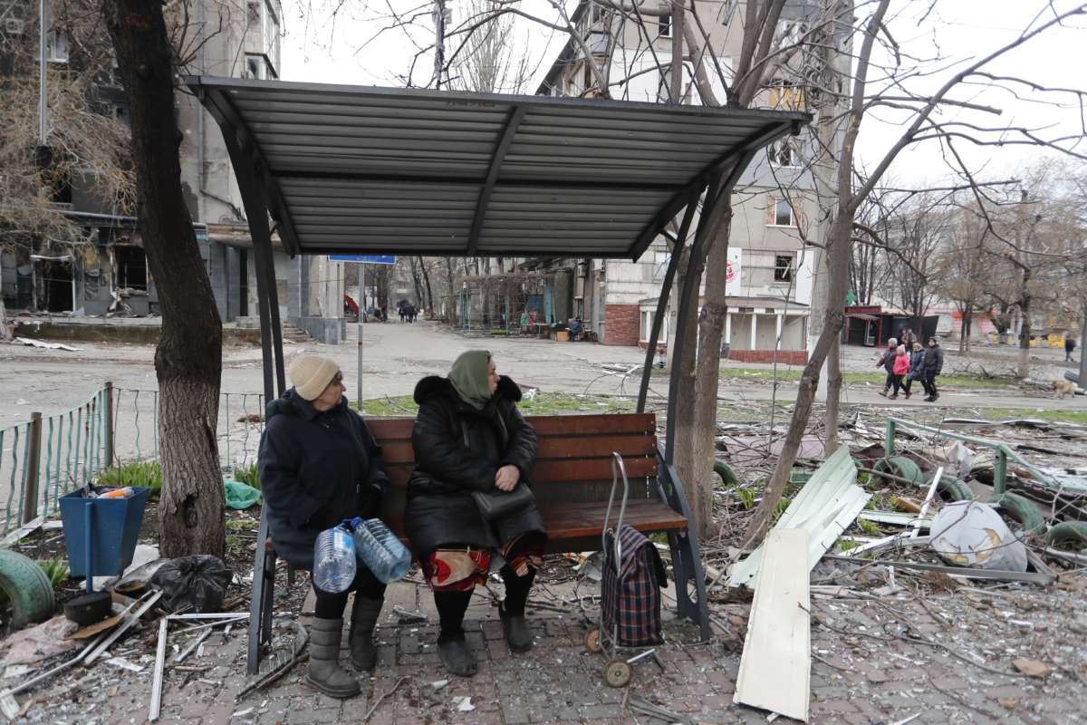 People sit outdoors in Mariupol, Ukraine, on April 14, 2022.