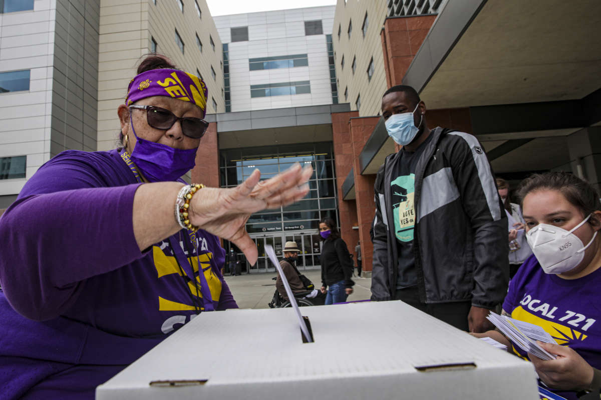 Lillian Cabral, head clerk supervisor for 44 years at Los Angeles County+USC Medical Center, casts her ballot at a strike authorization polling held by Service Employees International Union's local chapter, SEIU Local 721 in front of the hospital on April 20, 2022, in Los Angeles, CA.