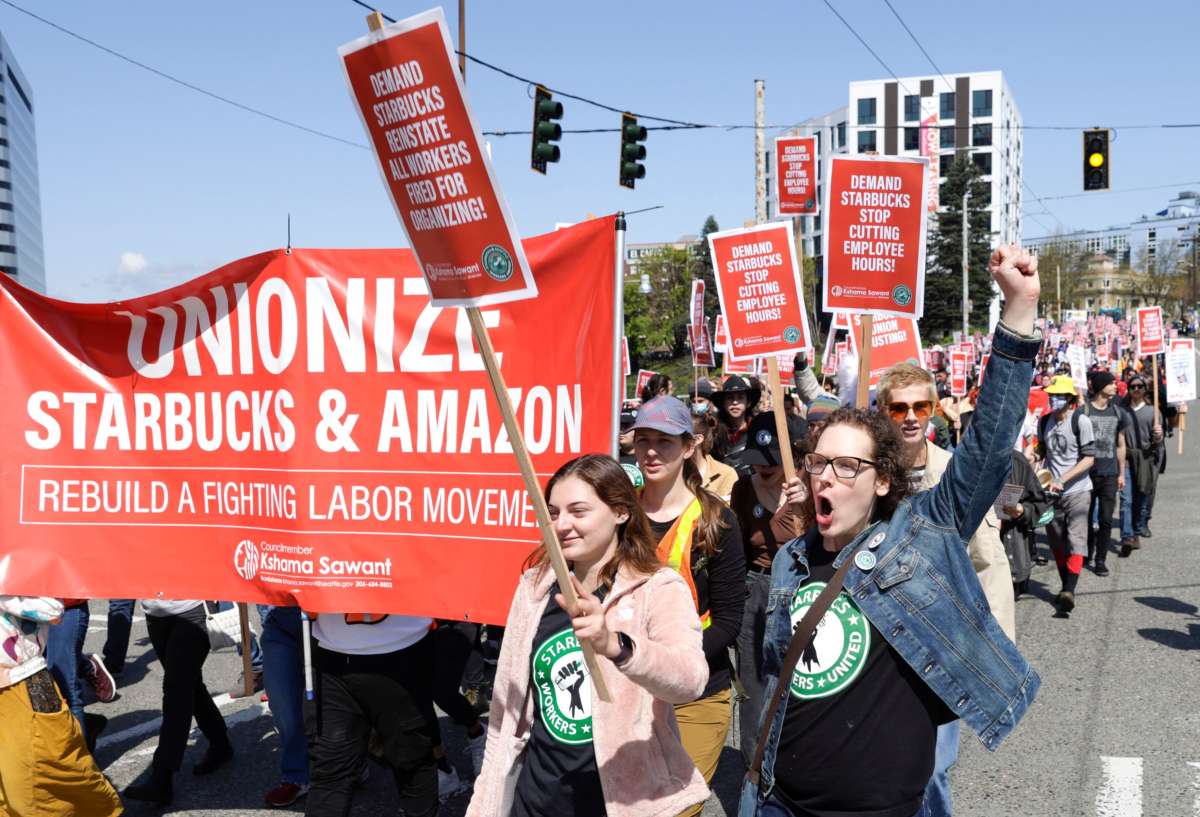 People march in the middle of East Pine Street during the "Fight Starbucks' Union Busting" rally and march in Seattle, Washington, on April 23, 2022.