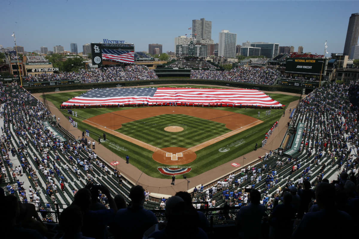 A flag is unfurled on the field prior to a game between the Chicago Cubs and the St. Louis Cardinals at Wrigley Field on June 11, 2021, in Chicago, Illinois.