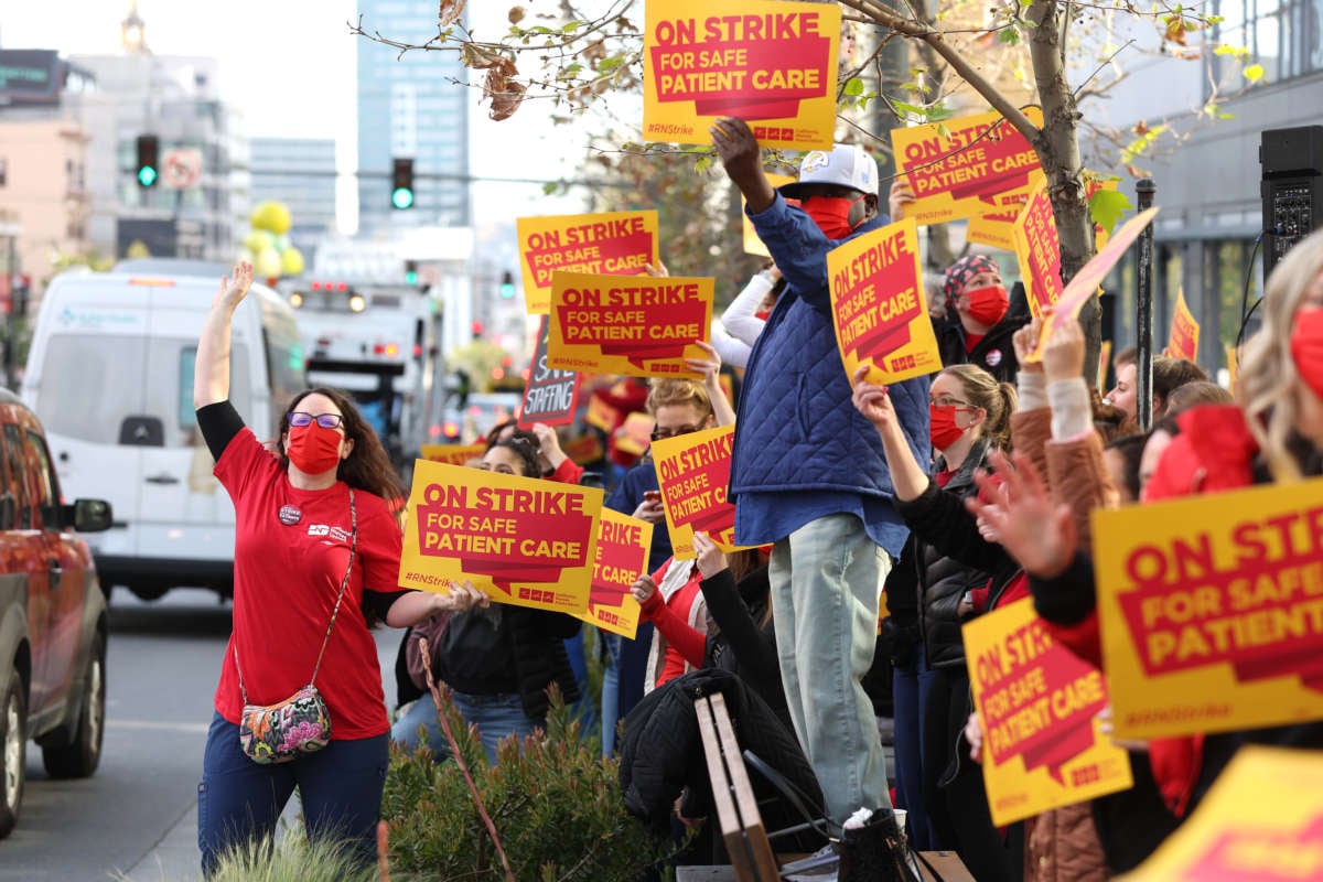 Sutter Health nurses and health care workers hold signs as they participate in a one day strike outside of the California Pacific Medical Center Van Ness Campus on April 18, 2022, in San Francisco, California.