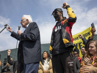 Sen. Bernie Sanders joins Amazon Labor Union President Chris Smalls at a rally on the eve of the union election for the LDJ5 Amazon sorting center on April 24, 2022, in Staten Island, New York. Smalls successfully organized the JFK8 Amazon fulfillment center across the street, making it the first Amazon warehouse to unionize.