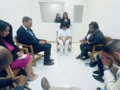 Representatives Jeff Leach, Joe Moody, Lacey Hull, Victoria Criado, Rafael Anchia, Toni Rose and James White pray with Melissa Lucio at Mountain View Unit in Gatesville, Texas, where the state houses women on death row.