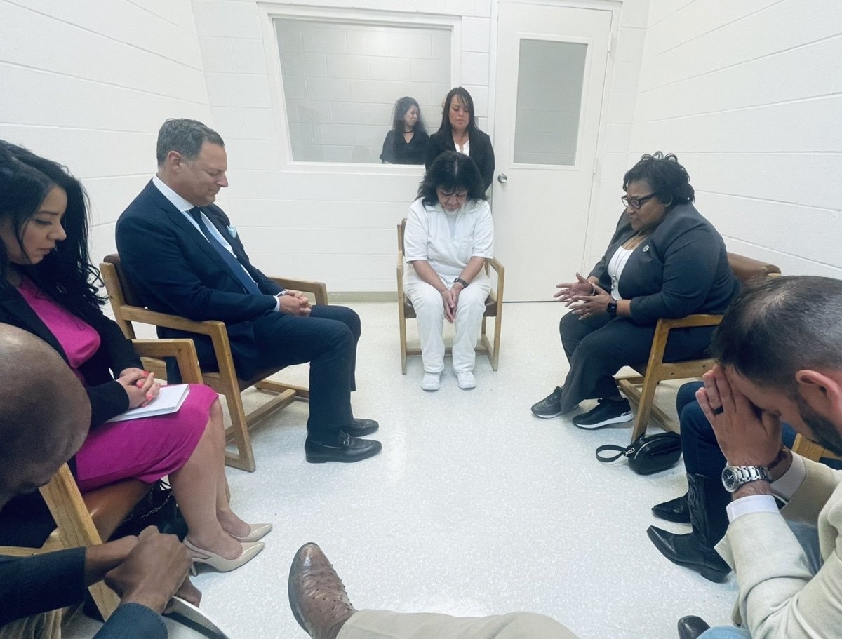 Representatives Jeff Leach, Joe Moody, Lacey Hull, Victoria Criado, Rafael Anchia, Toni Rose and James White pray with Melissa Lucio at Mountain View Unit in Gatesville, Texas, where the state houses women on death row.