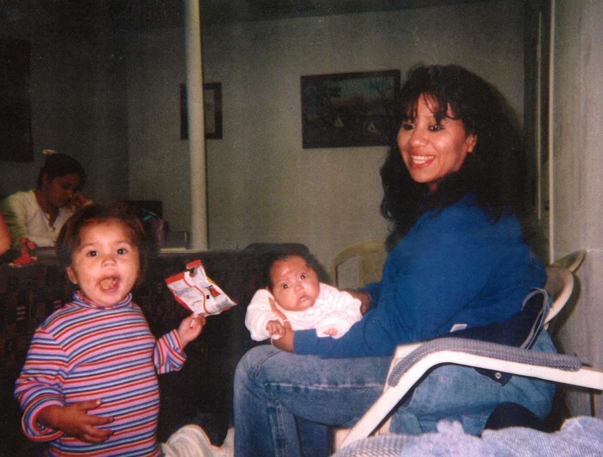 Melissa Lucio sits with her daughters Mariah and Adriana.