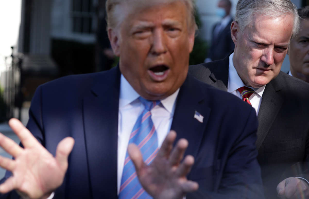 President Donald Trump speaks as White House Chief of Staff Mark Meadows listens prior to Trump's Marine One departure from the South Lawn of the White House on July 29, 2020, in Washington, D.C.