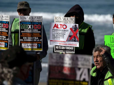 Advocates and migrants from the Alianza Migrante organization protest against the Biden administration's migration policies and the possible use of robot dogs to patrol the border, during the visit of U.S. ambassador in Mexico Ken Salazar to Tijuana, near the U.S.-Mexico border fence, in Playas de Tijuana, Baja California state, Mexico, on February 14, 2022.