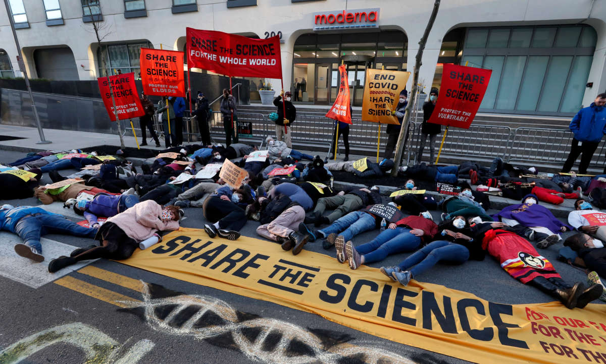 Demonstrators stage a "die-in" in front of the Moderna headquarters during a protest in Cambridge, Massachusetts, on April 28, 2022.