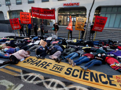 Demonstrators stage a "die-in" in front of the Moderna headquarters during a protest in Cambridge, Massachusetts, on April 28, 2022.