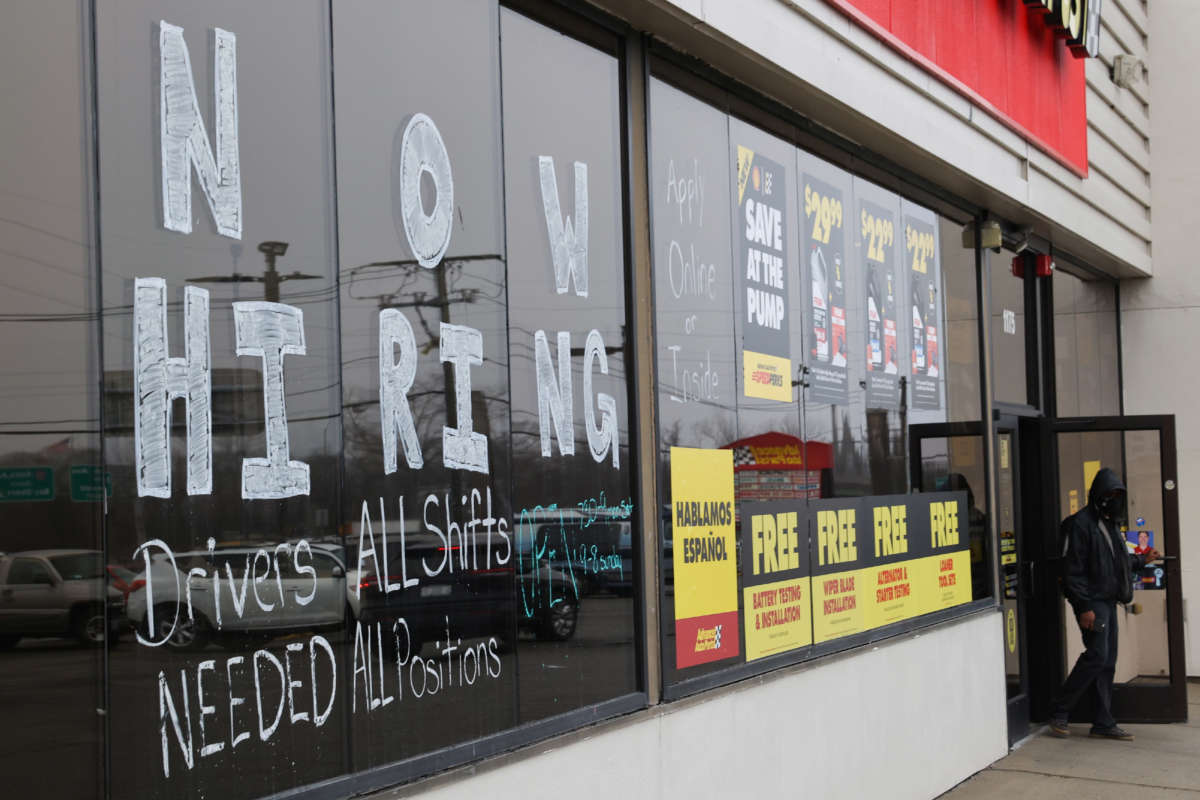 A large Now Hiring advertisement is pictured on the windows of the Advance Auto Parts store in Bay Shore, New York, on March 24, 2022.