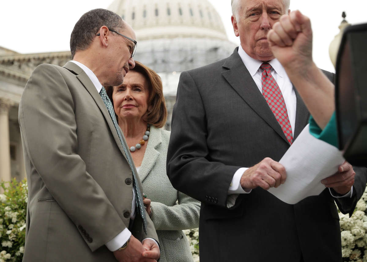 House Minority Leader Rep. Nancy Pelosi, second left, talks to Labor Secretary Thomas Perez, left, next to House Minority Whip Rep. Steny Hoyer, right, during a news conference on April 21, 2016, on Capitol Hill in Washington, D.C.