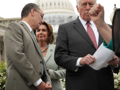 House Minority Leader Rep. Nancy Pelosi, second left, talks to Labor Secretary Thomas Perez, left, next to House Minority Whip Rep. Steny Hoyer, right, during a news conference on April 21, 2016, on Capitol Hill in Washington, D.C.