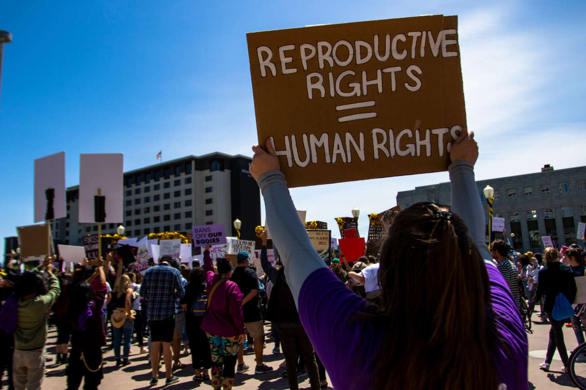 A protester holds a placard up that says Reproductive rights = Human rights during a protest in Reno, Nevada, on May 7, 2022.