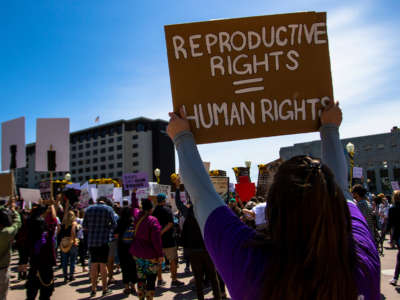 A protester holds a placard up that says Reproductive rights = Human rights during a protest in Reno, Nevada, on May 7, 2022.