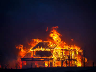 A home burns after a fast moving wildfire swept through the area in the Centennial Heights neighborhood of Louisville, Colorado, on December 30, 2021.