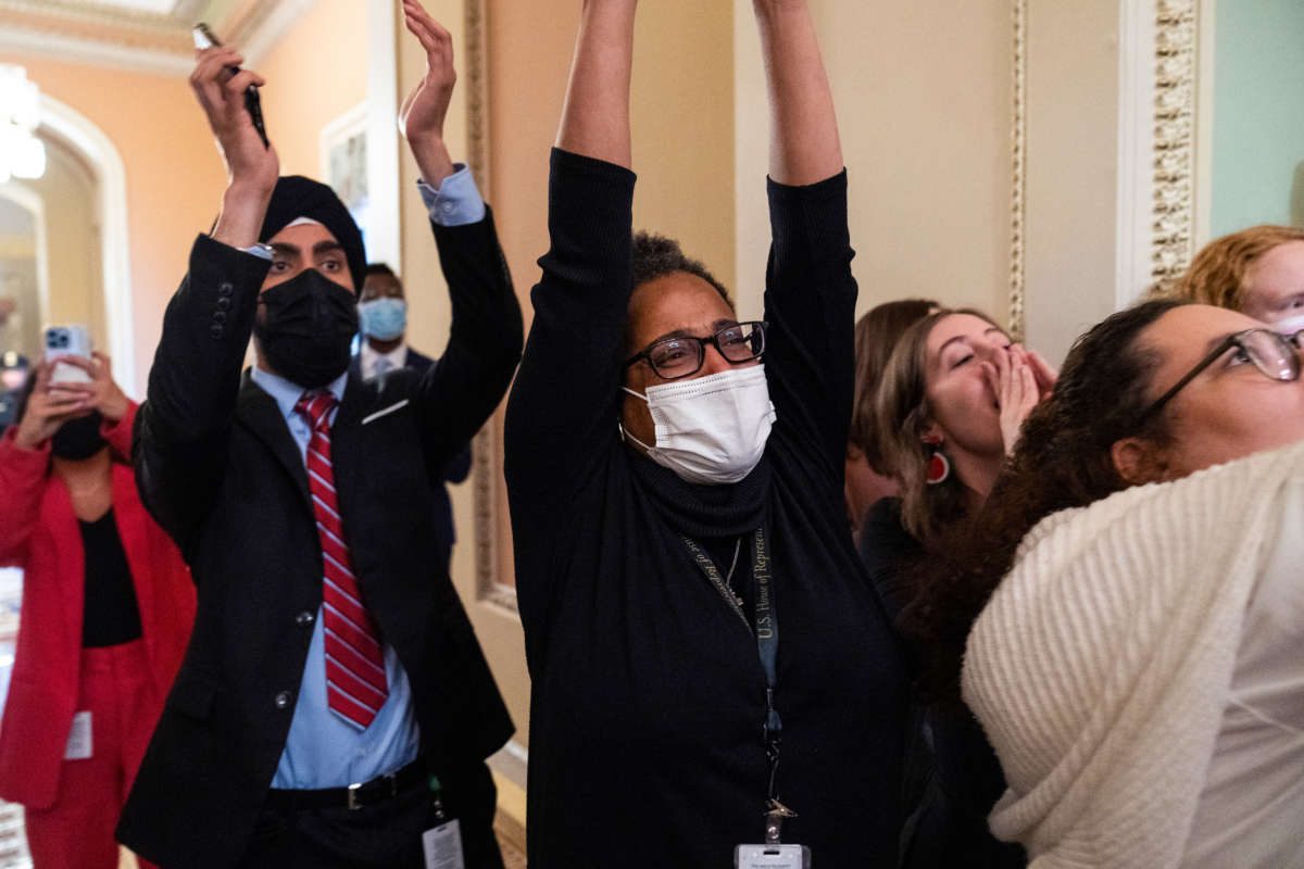 Congressional aides cheer as the Senate voted to confirm Ketanji Brown Jackson to the Supreme Court in the U.S. Capitol on April 7, 2022.