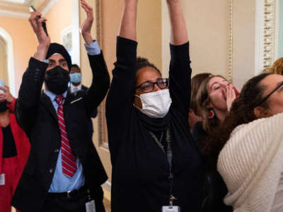 Congressional aides cheer as the Senate voted to confirm Ketanji Brown Jackson to the Supreme Court in the U.S. Capitol on April 7, 2022.