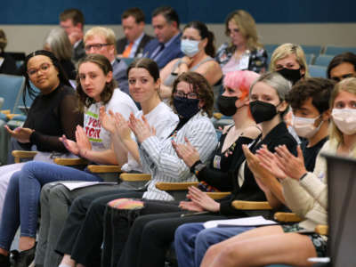 Lyman High School students, with students from other Seminole County high schools, applaud remarks supporting their position during a meeting of the Seminole County School Board on May 10, 2022. The students are voicing what they say is censorship of the just-published Lyman yearbook.