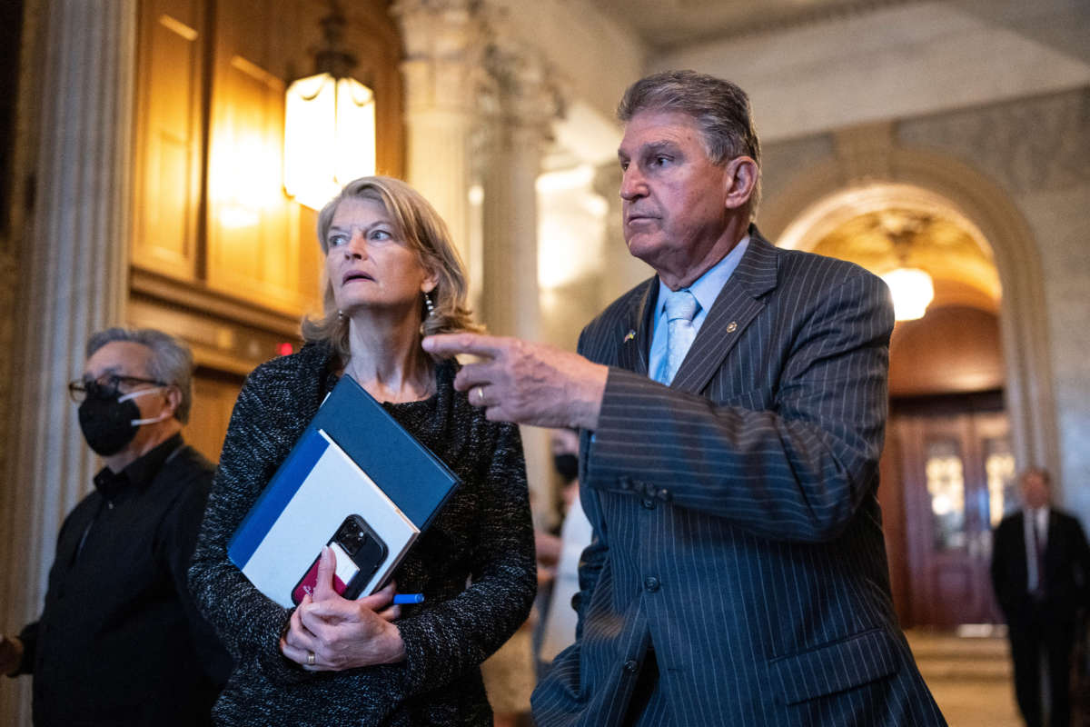 Sen. Lisa Murkowski talks with Sen. Joe Manchin outside the Senate Chamber at the U.S. Capitol on April 7, 2022, in Washington, D.C.