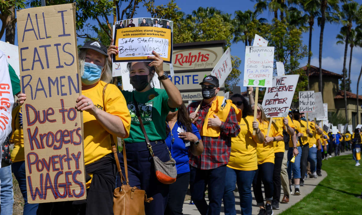 About 200 union workers stage a picket along the street and then in front of the entrance to Ralphs in Tustin, California, on February 28, 2022.