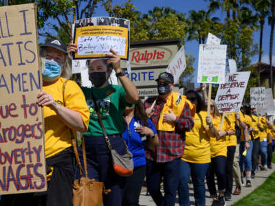 About 200 union workers stage a picket along the street and then in front of the entrance to Ralphs in Tustin, California, on February 28, 2022.