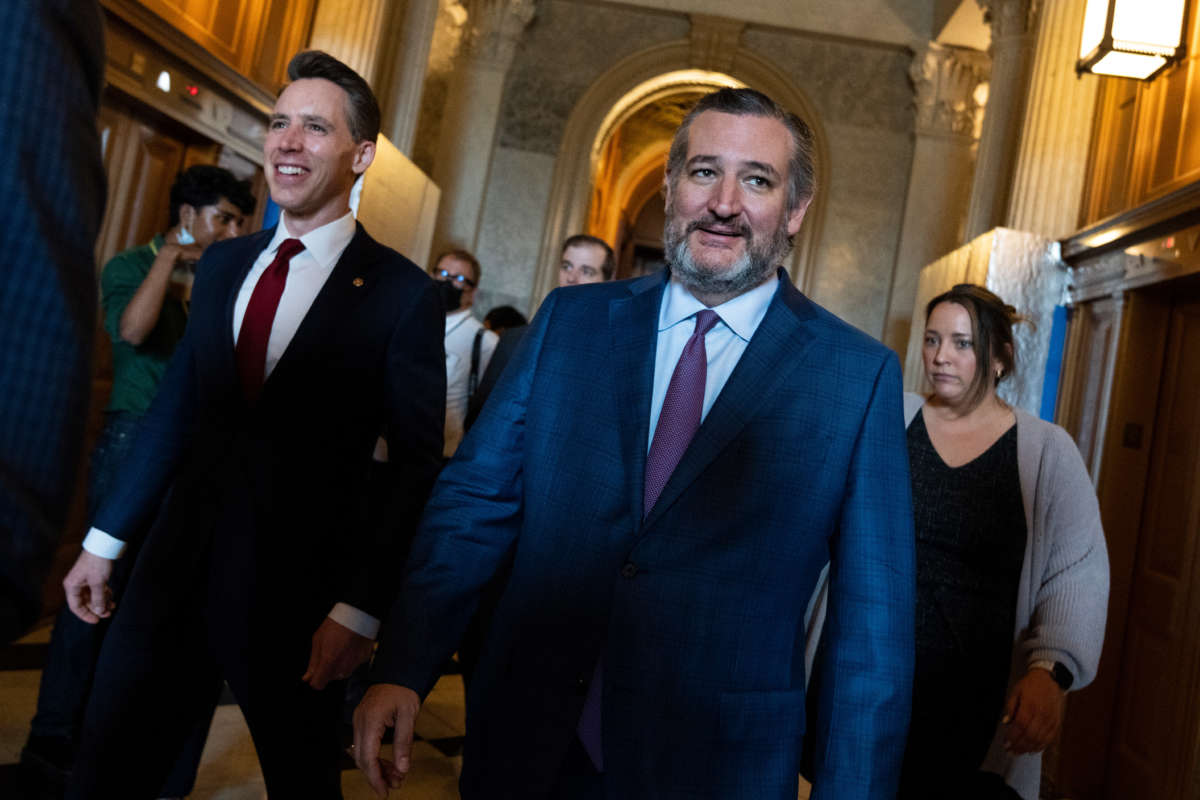 Senators Ted Cruz, right, and Josh Hawley are seen outside the Senate chamber on May 3, 2022.