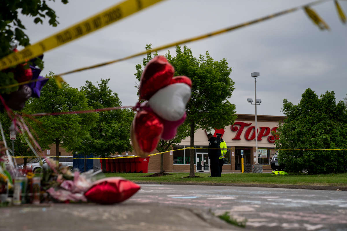 People gather at the scene of a mass shooting at Tops Friendly Market at Jefferson Avenue and Riley Street on May 16, 2022, in Buffalo, New York.