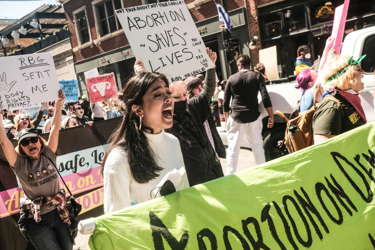 Protesters hold placards and march through downtown Detroit in support of Roe v Wade on May 7, 2022.