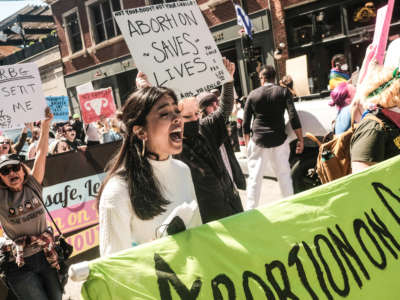 Protesters hold placards and march through downtown Detroit in support of Roe v Wade on May 7, 2022.