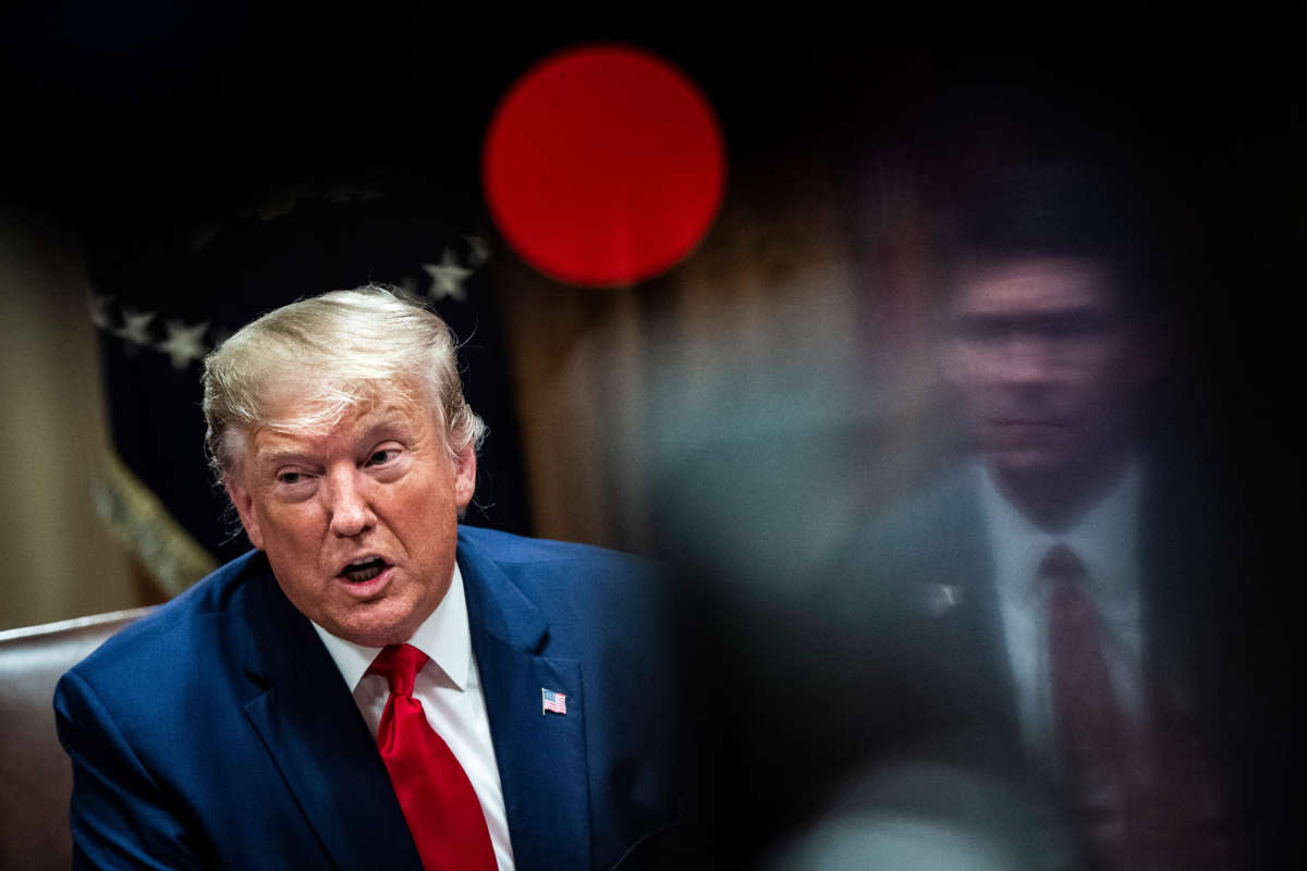 President Donald Trump, flanked by Secretary of Defense Mark Esper, speaks during a meeting with senior military leaders in the Cabinet Room at the White House on October 7, 2019, in Washington, D.C.