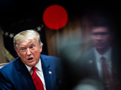 President Donald Trump, flanked by Secretary of Defense Mark Esper, speaks during a meeting with senior military leaders in the Cabinet Room at the White House on October 7, 2019, in Washington, D.C.