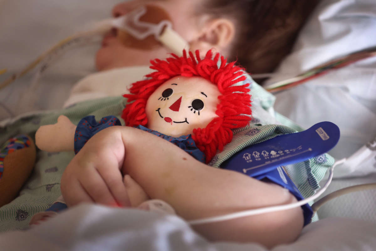 A child being treated for respiratory issues due to COVID-19 in the ICU