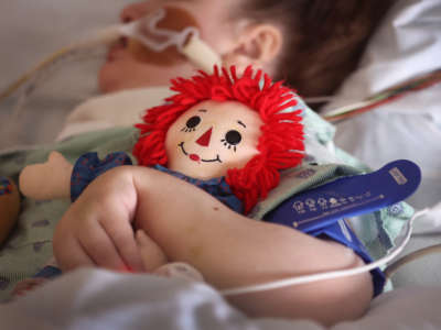 A child being treated for respiratory issues due to COVID-19 in the ICU