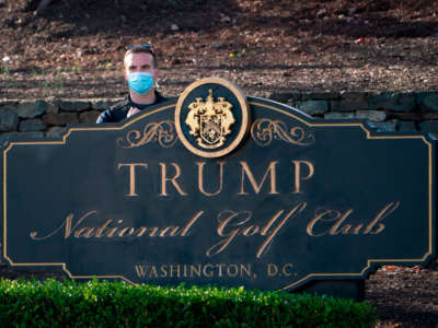 A secret service agent looks on before the motorcade with then-President Donald Trump passes at the Trump National Golf Club in Sterling, Virginia, on November 26, 2020.