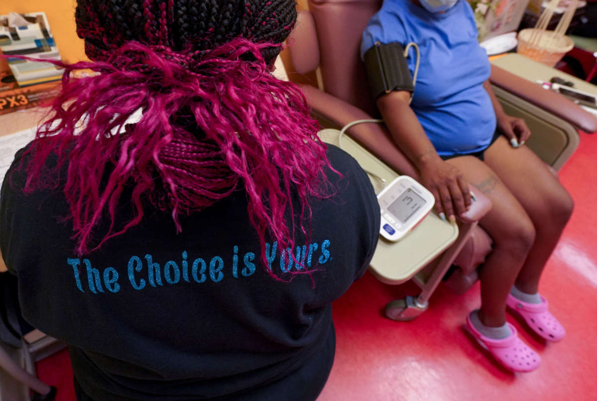 A technician wears a shirt supporting a woman's right to abortion while checking a patient's blood pressure at Jackson Women's Health Organization -- the only remaining abortion clinic in the state -- on June 29, 2021, in Jackson, Mississippi.