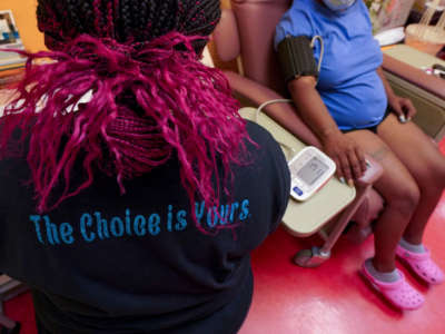 A technician wears a shirt supporting a woman's right to abortion while checking a patient's blood pressure at Jackson Women's Health Organization -- the only remaining abortion clinic in the state -- on June 29, 2021, in Jackson, Mississippi.